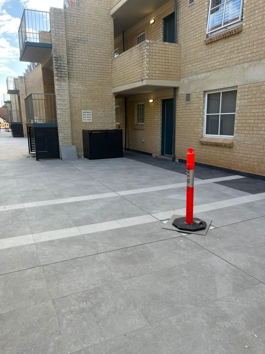 Completed tiled walkways and communal areas at Hillarys strata complex